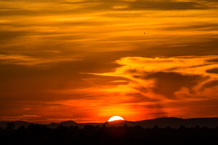 Beautiful orange sunset sunset behide the mountain.の写真素材