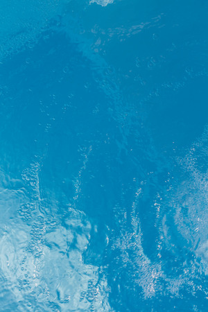 Beautiful pattern of blue water reflecting the sun.Verticalの写真素材