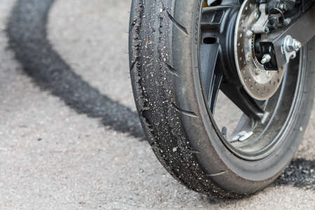 Patterned of wheel racing motorcycle on the road.