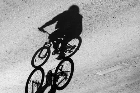 shadow of the bicycle and the cyclist on the road.の写真素材