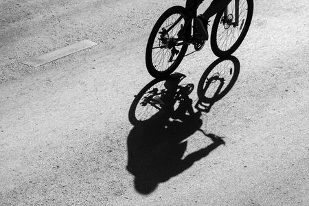 shadow of the bicycle and the cyclist on the road.の写真素材