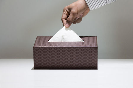 Men's hand holding tissue paper.の写真素材