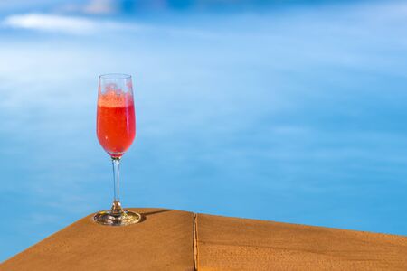 Glass of cocktail on the pool nosing at the tropical hotel.の写真素材