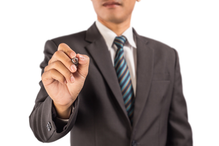 Man wearing a business suit pretending to write something on the air.の写真素材
