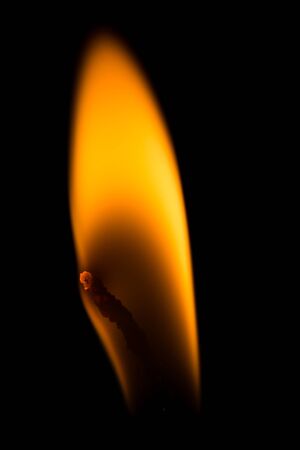 Macro light light of yellow candle at night ; candlewick burningの写真素材