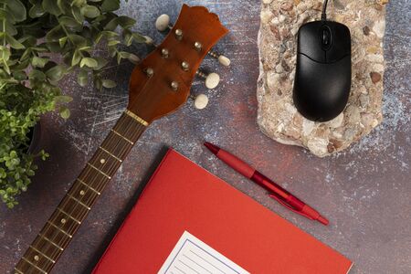 Office desk for music writers with an instrument, notebook and computer. Top view conceptの写真素材