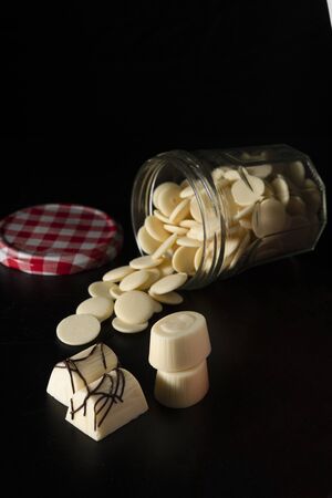 White small pieces of white chocolate in a glass jarの写真素材