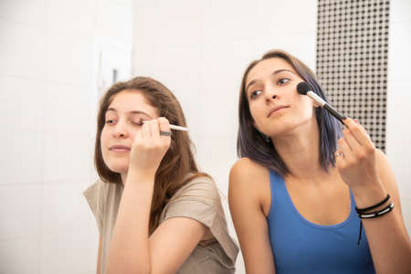 Teenage Girls Playing and Doing Their First Make Upの写真素材