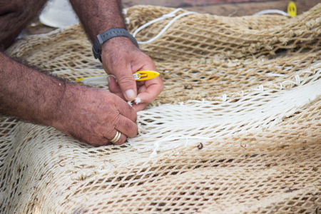 Hands weaving fishing net