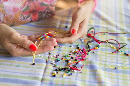 Woman making bracelet of beadsの写真素材