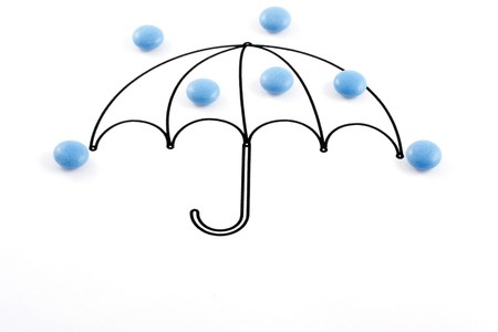 Umbrella and pills on white backgroundの写真素材