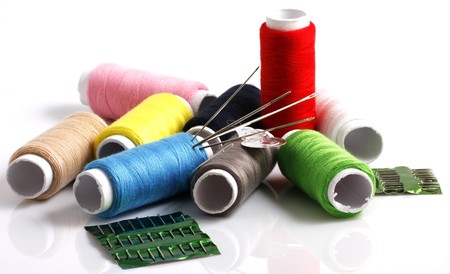 Set of colorful spools of thread isolated on white background