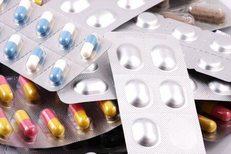 Pills of many shapes and colors grouped togetherの写真素材