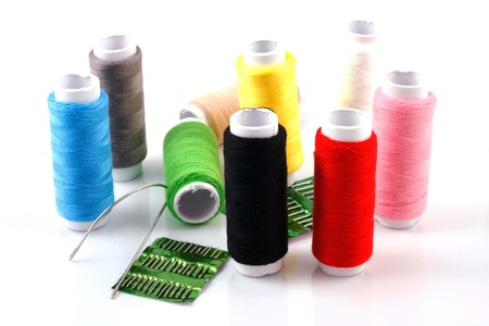 Set of colorful spools of thread isolated on white background