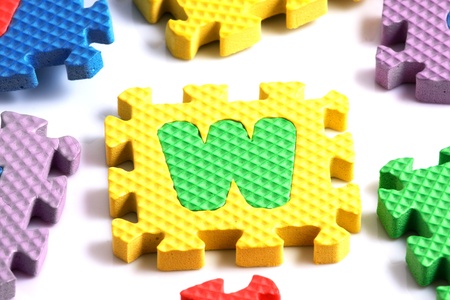 Alphabet puzzle pieces on white backgroundの写真素材