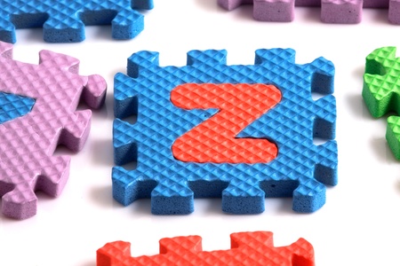 Alphabet puzzle pieces on white backgroundの写真素材