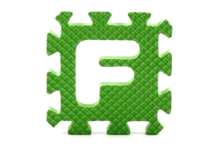 Alphabet puzzle pieces on white backgroundの写真素材