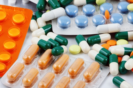 Pills of many shapes and colors grouped togetherの写真素材