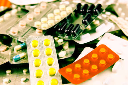Pills of many shapes and colors grouped together.の写真素材