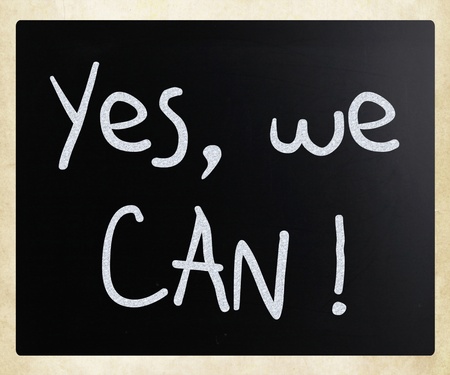 "Yes, we can!" handwritten with white chalk on a blackboardの写真素材