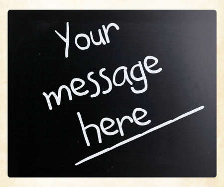 "Your message here" handwritten with white chalk on a blackboardの写真素材