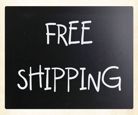 "Free shipping" handwritten with white chalk on a blackboardの写真素材