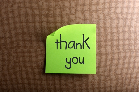 Thank you - colorful sticky notes with handwriting on cork bulletin board.の写真素材