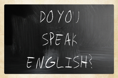 "Do you speak english" handwritten with white chalk on a blackboardの写真素材