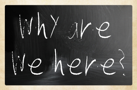 "why are we here" handwritten with white chalk on a blackboardの写真素材