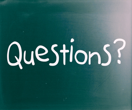 "Question" handwritten with white chalk on a blackboardの写真素材