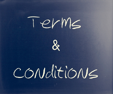 "Terms & Conditions" handwritten with white chalk on a blackboard.の写真素材