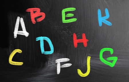 alphabet handwritten with chalk on a blackboardの写真素材