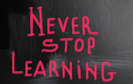 never stop learning handwritten with chalk on a blackboardの写真素材