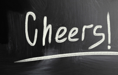 cheers handwritten with chalk on a blackboardの写真素材