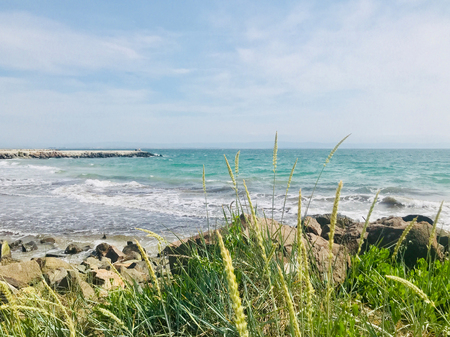 Beach and sea in bright sunlightの写真素材