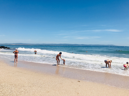 Pomorie, Bulgaria - May 30, 2018: View of the people spending time on the beach.のeditorial素材