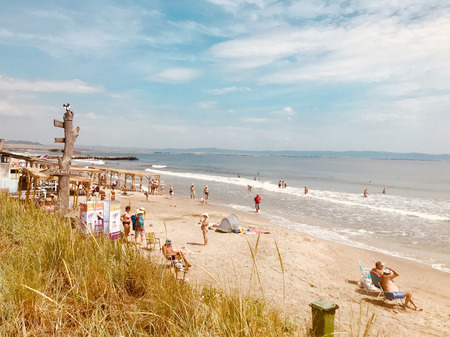 Pomorie, Bulgaria - May 30, 2018: View of the people spending time on the beach.のeditorial素材