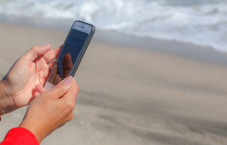 Pomorie, Bulgaria - October 06, 2018: Photo of a woman using smart phone.のeditorial素材