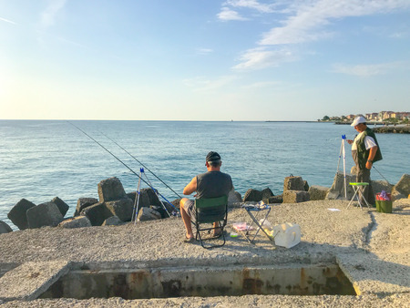 Pomorie, Bulgaria - June 12, 2019: Fishermen Hunt Fresh Fish Behind The Coasts Of The Sea Town.のeditorial素材