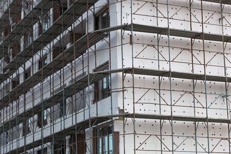The process of renovating a new building. New construction, exterior wall insulation.