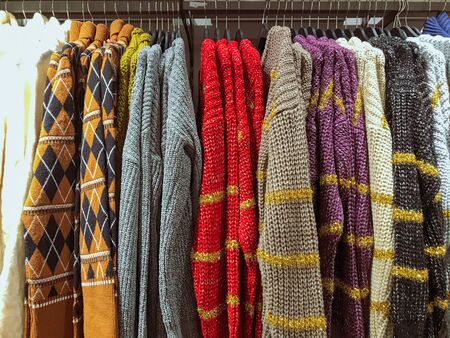 Different types of winter sweaters for sale at a nearby store