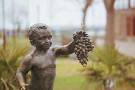 Pomorie, Bulgaria - February 07, 2020: "The Boy with Grapes" - The Statue Symbol Of The Town Of Pomorie.のeditorial素材
