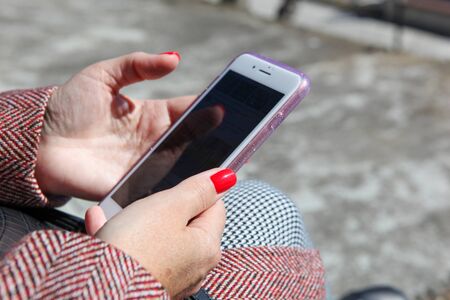 Young Girl Uses His Cell Phone To Check Your Electronic Mail.