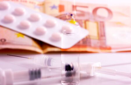Double exposure image of euro banknotes and medicines.の写真素材