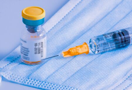 Injection solution in a sealed vial and disposable plastic medical syringe.