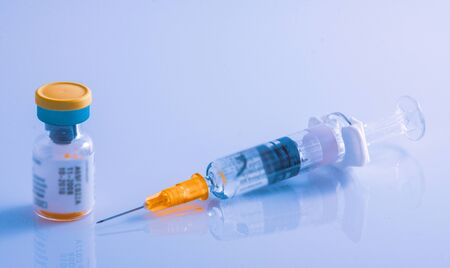 Injection solution in a sealed vial and disposable plastic medical syringe.の写真素材