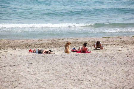 Pomorie, Bulgaria - June 07, 2020: People relaxing on the beach.のeditorial素材