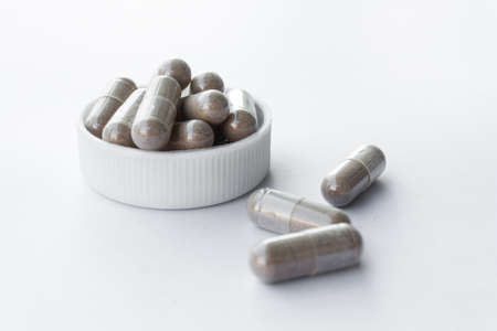 Capsules spilled on white backgroundの写真素材