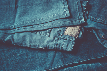 Close up blue jeans in a stack, top view, vintage color style.の写真素材