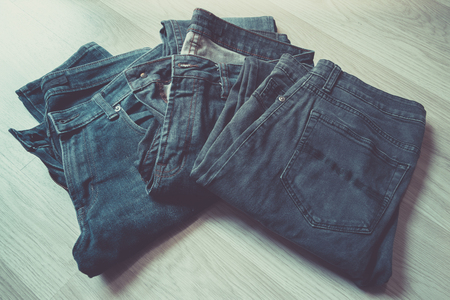 Medium shot blue jeans in a stack, top view, vintage color style.の写真素材